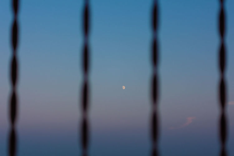 Close-up of barbed wire against sky at dusk