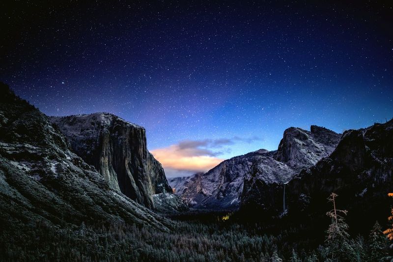 Scenic view of mountains against sky at night