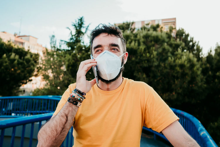 Portrait of man wearing sunglasses against trees