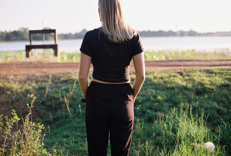 Rear view of woman standing on field