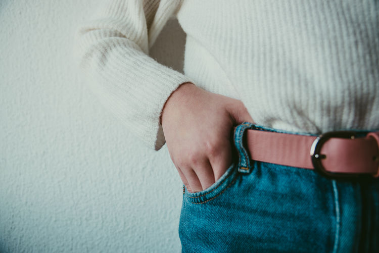Cropped image of girl with hands in pocket