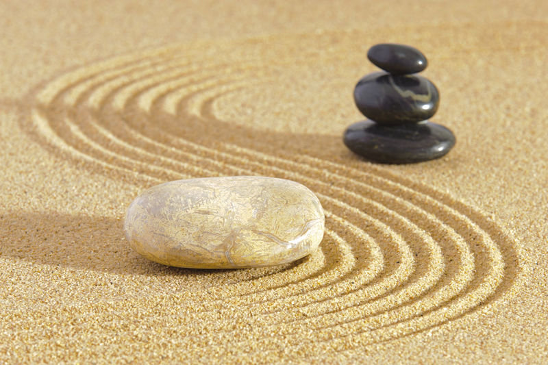 Japanese zen garden in sand with stone