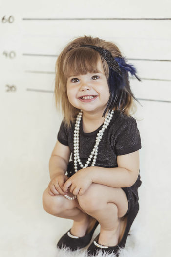 Charming baby in gangster costume at the police station