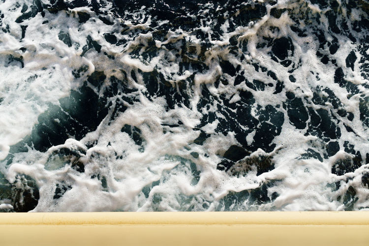 Digital composite image of water splashing in sea