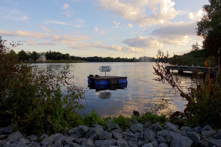 Scenic view of river against sky during sunset