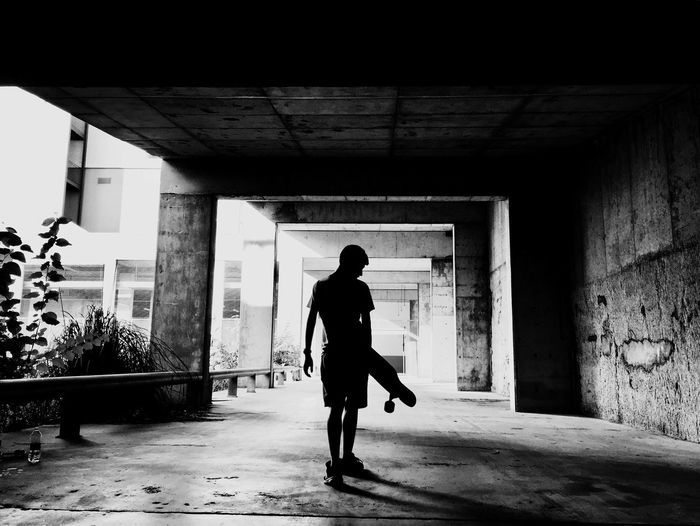 Silhouette woman walking in corridor