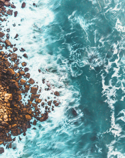 High angle view of rocks by sea
