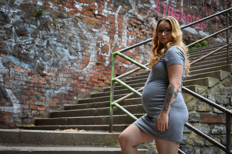 Young pregnant woman on stairs