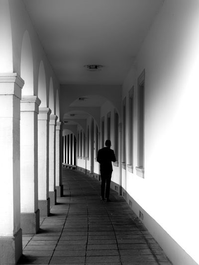 Rear view of woman walking in corridor