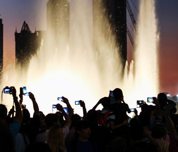 Panoramic view of people photographing at night