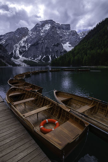 Typical boats the water at lake braies in the dolomites, near cortina d'ampezzo