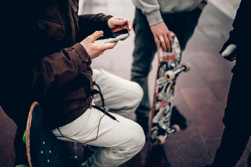 Adventure Close-up Communication Connection Day Holding Human Hand Leisure Activity Lifestyles Men Mobile Phone Outdoors People Portable Information Device Real People Smart Phone Technology Two People Wireless Technology Women