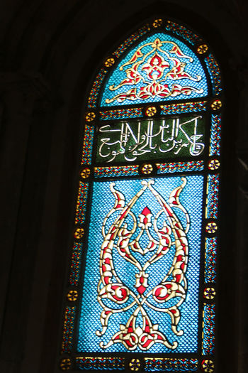 Low angle view of text on glass wall