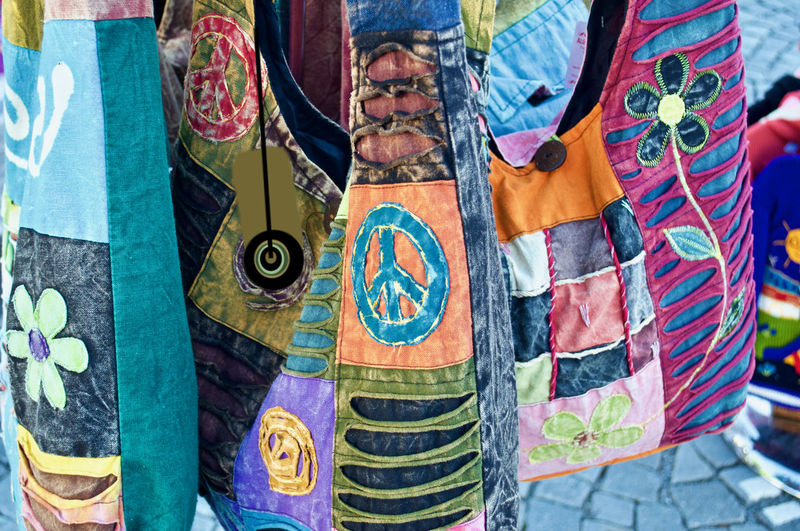 Close-up of clothes hanging on graffiti