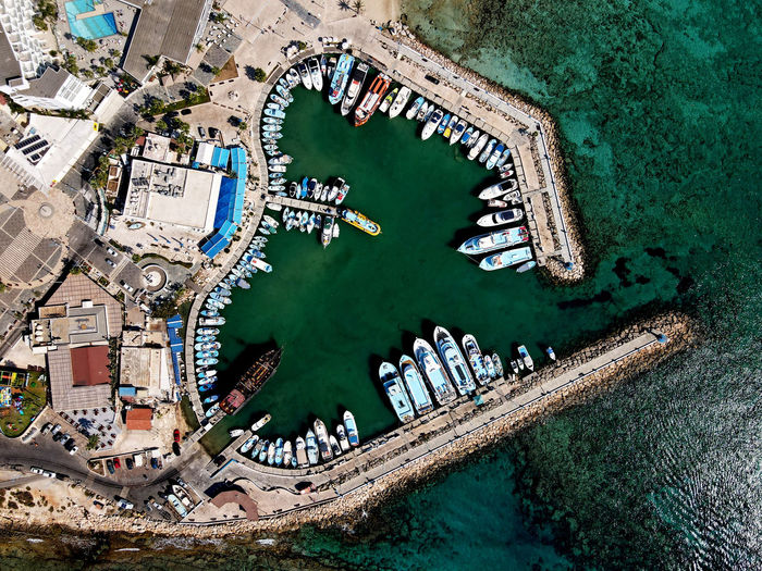 Aerial view of boat moored at sea by town