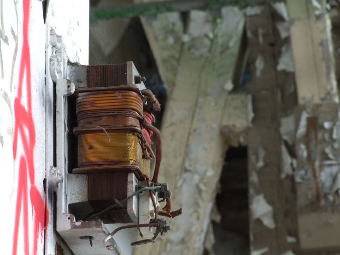Close-up of electric meter on wall of old building
