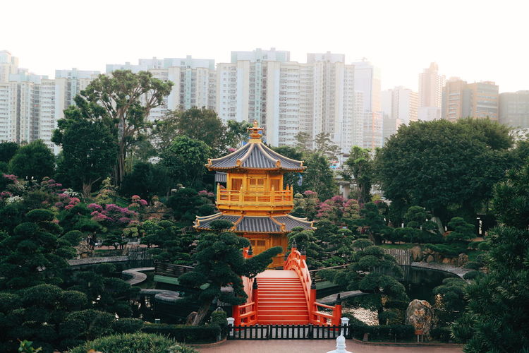 The atmosphere of a temple with view of the tree and city building