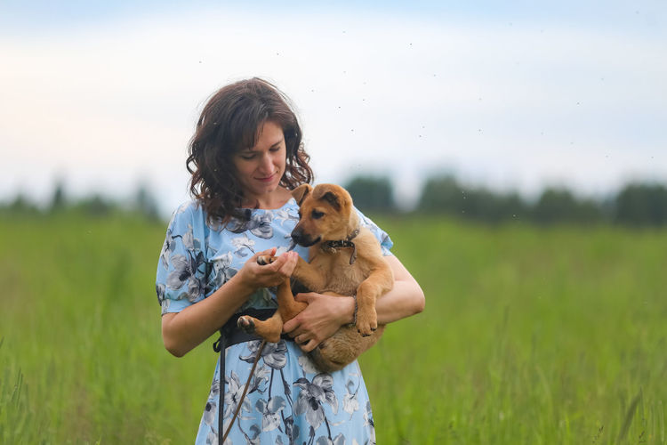 Woman with dog on field