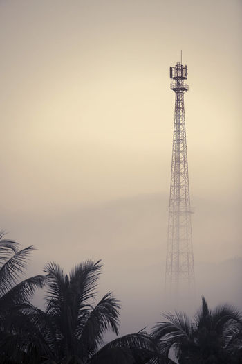 Telecom tower in the morning mist