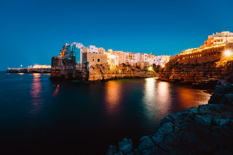 Night view of the village of polignano a mare illuminated by the lights