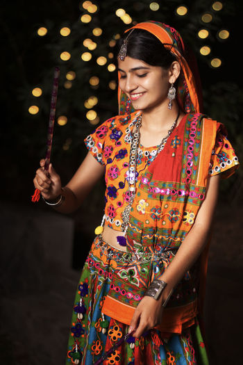 Portrait of young woman standing at night