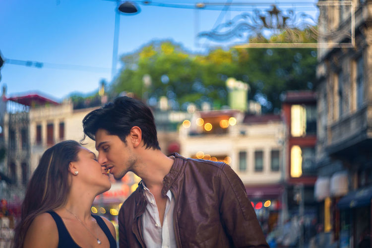 Young couple kissing on city street