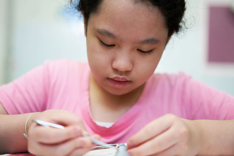 Close-up of young woman using mobile phone