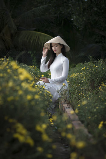 Woman sitting amidst plants