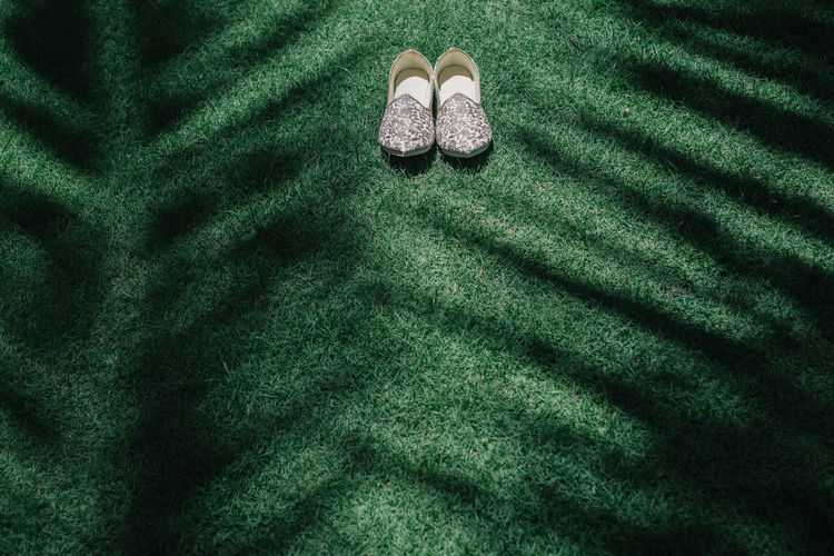 High angle view of traditional shoes on grass