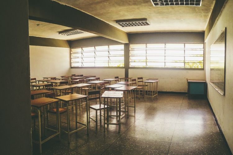 Empty chairs and desks in classroom