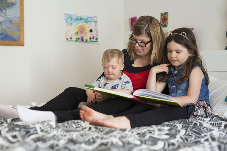 Mother reading with kids