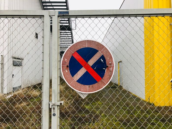 Road sign on chainlink fence