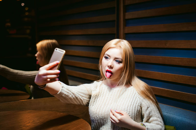 Close-up of woman taking selfie through mobile phone