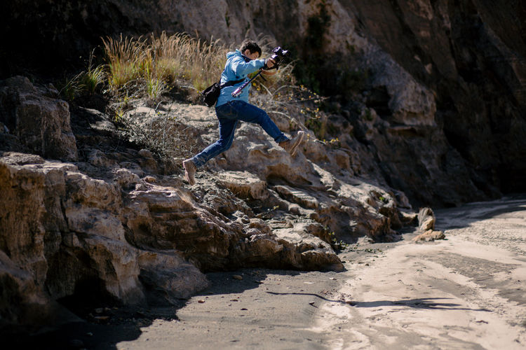 Man jumping on rock formation