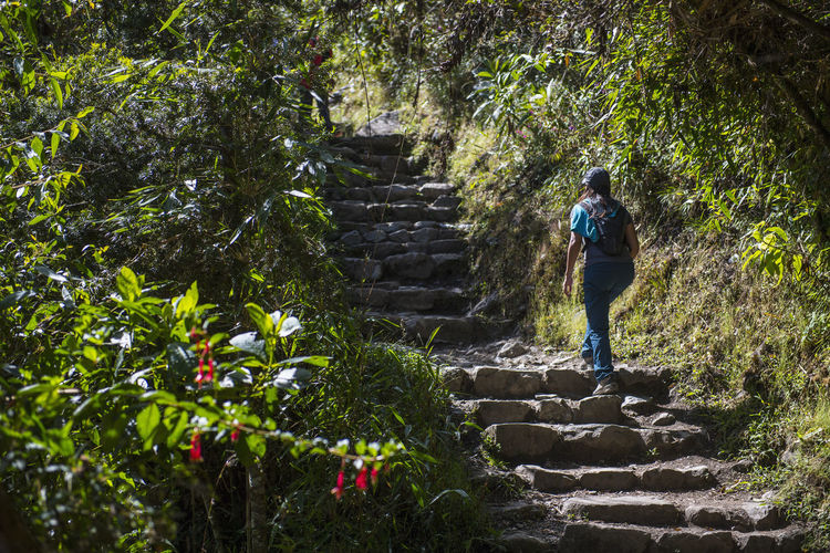 Woman moving up stairway on the inca trail close to machu picchu