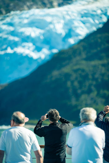 Rear view of people standing on mountain