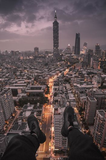 Low section of man against cityscape