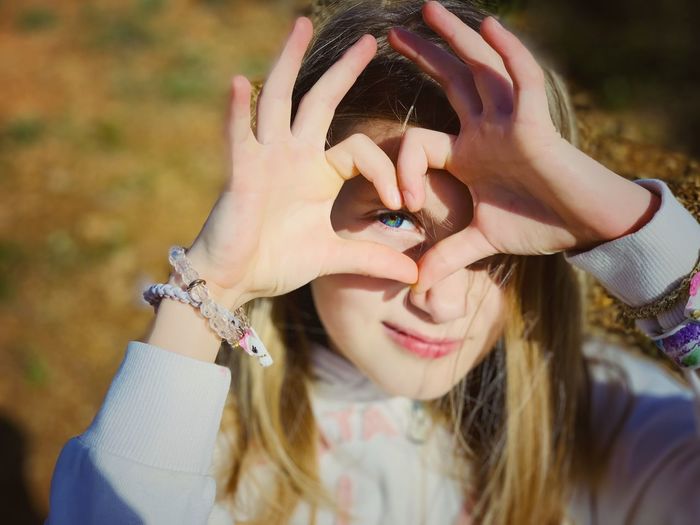 Portrait of woman holding hands