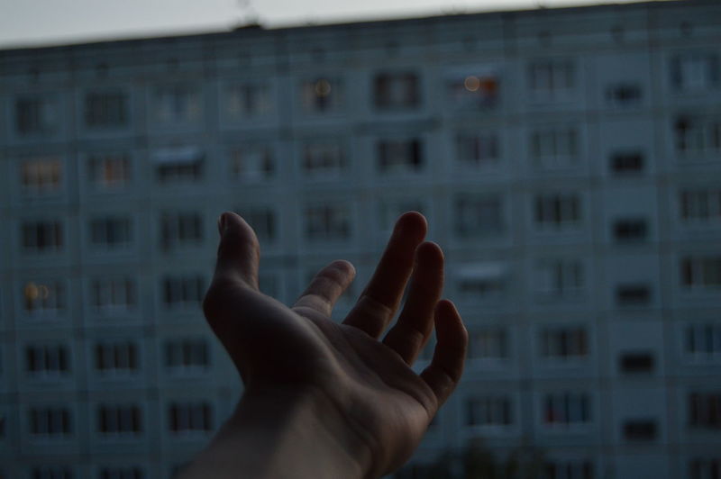 Close-up of person hand on window