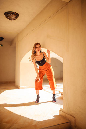 Portrait of beautiful woman standing in building