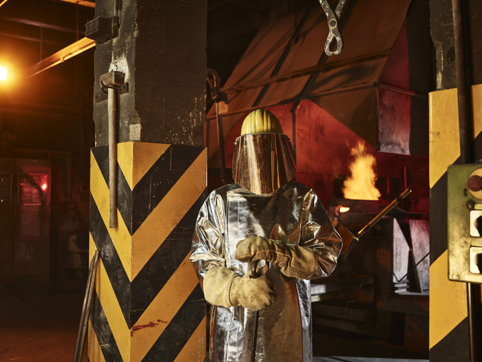Worker wearing protective workwear standing in foundry