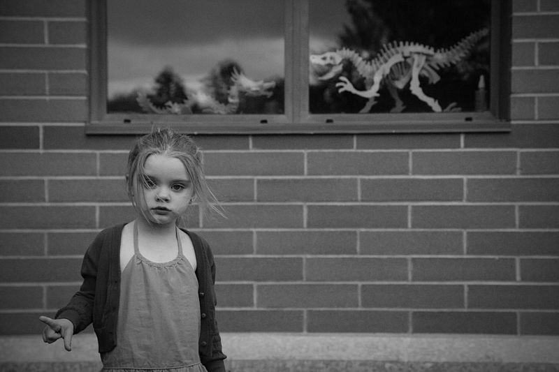 Close-up girl standing outside building