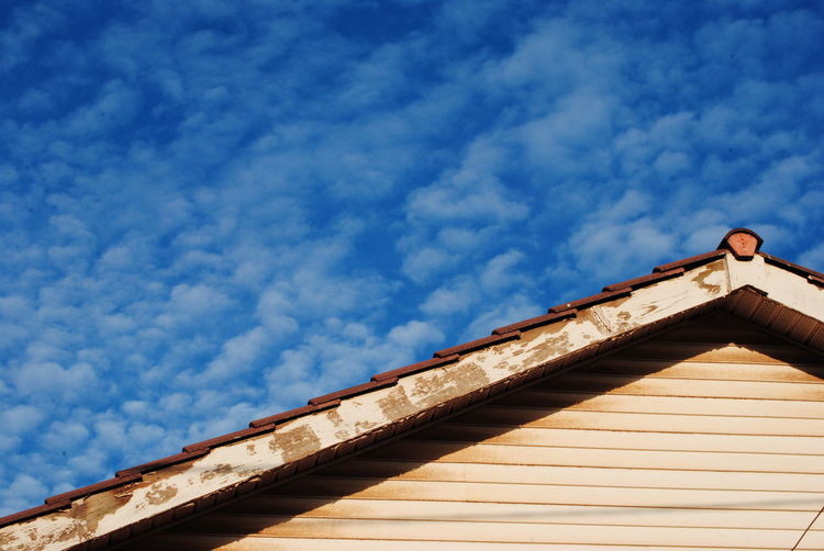 Low angle view of roof against blue sky