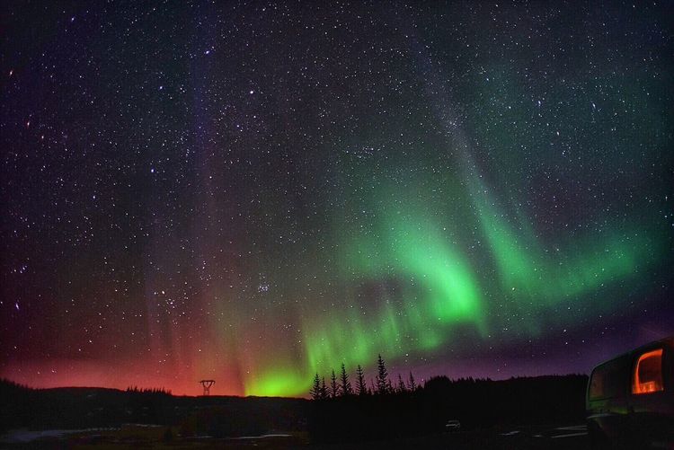 Scenic view of aurora borealis in sky at night