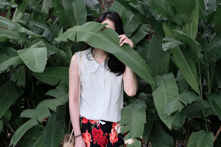 Woman standing by plants
