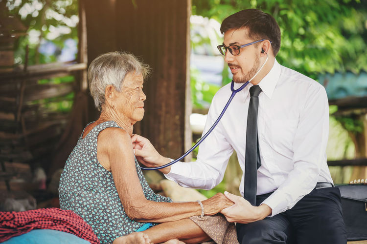 Doctor examining patient on bed