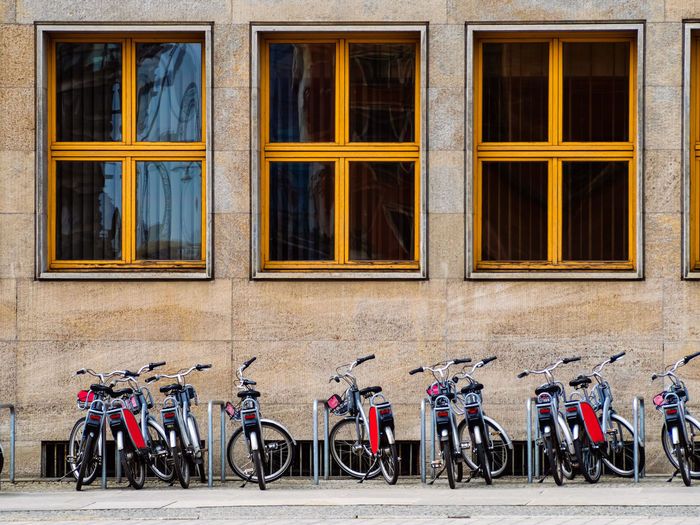 Bicycles parked on sidewalk by building