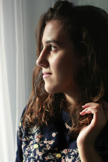Portrait of woman looking away at home