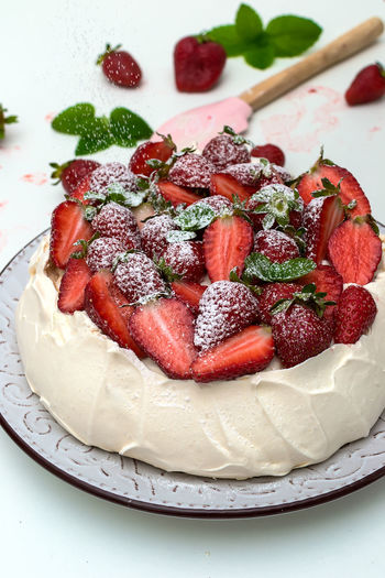 Homemade cake pavlova with strawberries on top - sweet food