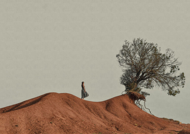 MAN STANDING IN DESERT